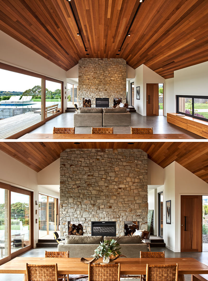 A large wood cathedral ceiling and a stone fireplace are the focal points in this modern house interior. #CathedralCeiling #StoneFireplace #ModernInterior #InteriorDesign