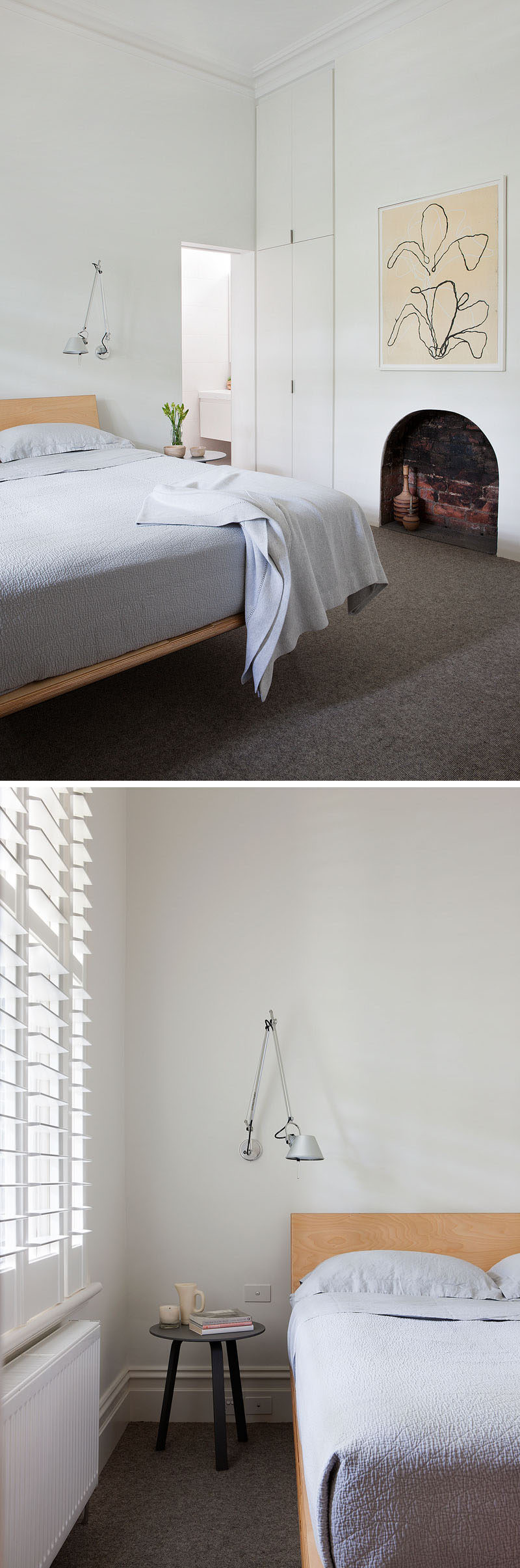 Simple white cabinets that blend into the wall have been included in this renovated bedroom, while an original fireplace has been kept as a design element. #Fireplace #Bedroom #UpdatedBedroom #WhiteCabinets