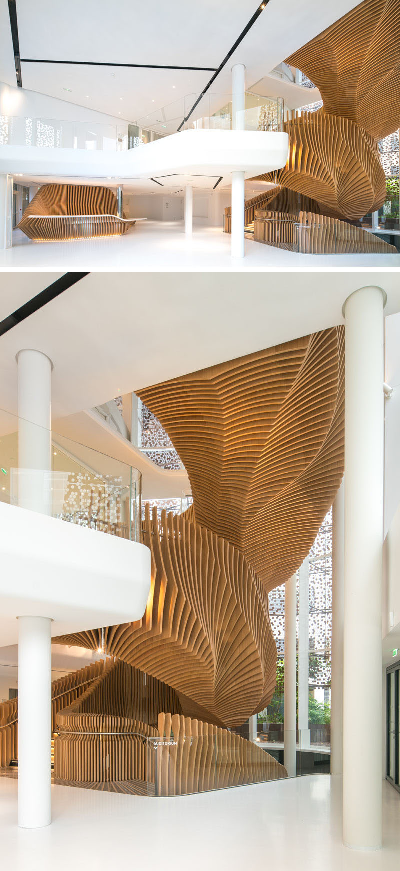 This large, sculptural, snake-like, wood staircase was installed in a new office building in France to connect the four floors of the building. #WoodStairs #SculpturalStairs #StairDesign #OfficeDesign #Stairs