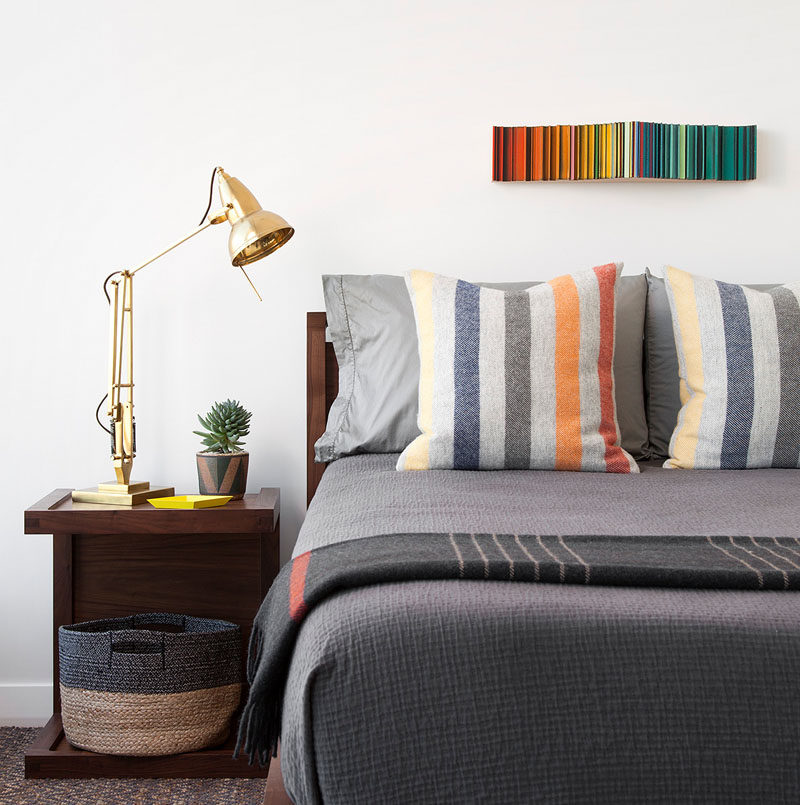 In this modern boy's bedroom, grey tones have been combined with colorful accents and a wood furniture for a contemporary appearance. #BedroomDesign #ModernBedroom #InteriorDesign