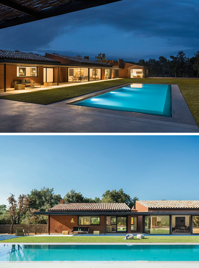 This house in Spain has a large landscaped lawn, a swimming pool and a covered patio area. #SwimmingPool #Backyard