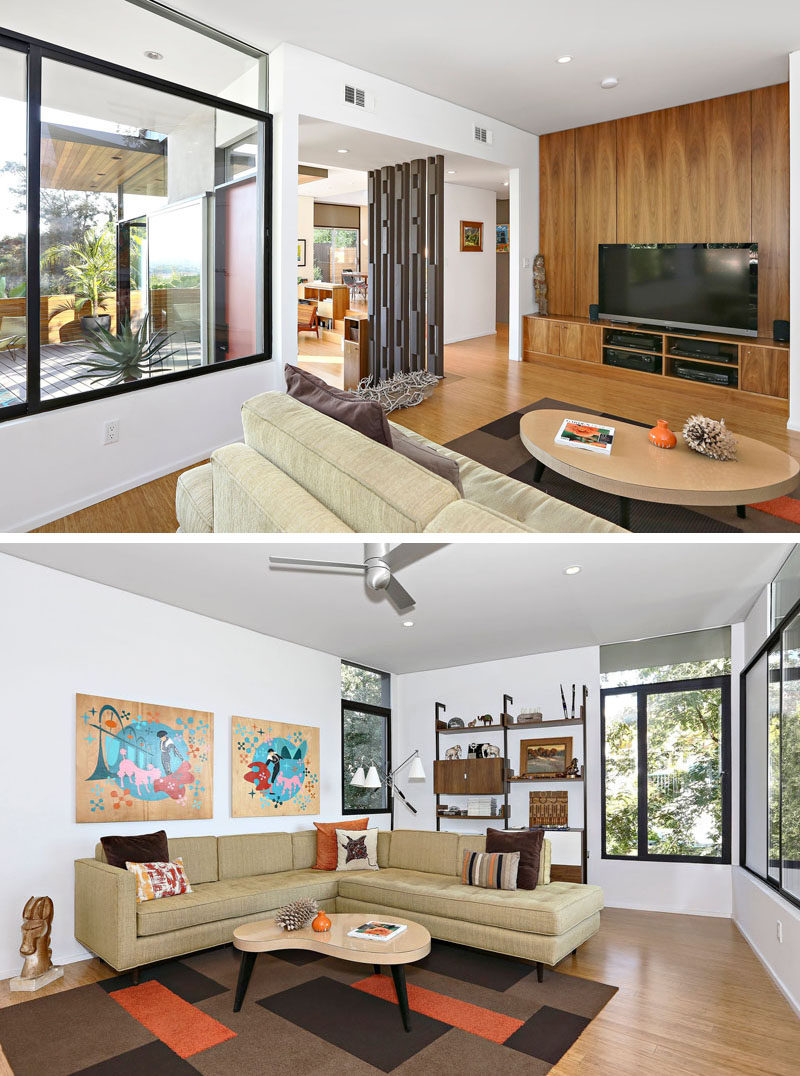 This contemporary living room has a warm wood accent wall, custom cabinetry and a comfortable sitting area. #LivingRoom #Walnut #WoodAccentWall