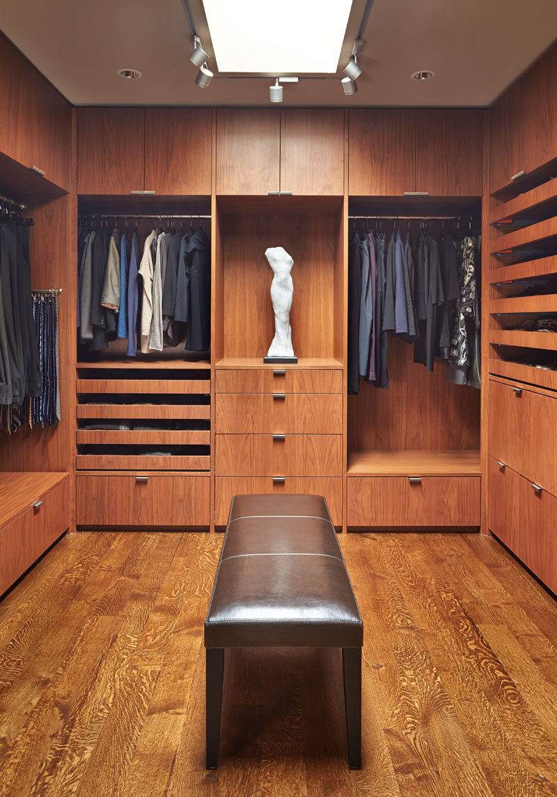 This modern walk-in dressing room has been fitted out with cabinets, shelving, racks and drawers. #WalkInCloset #DressingRoom