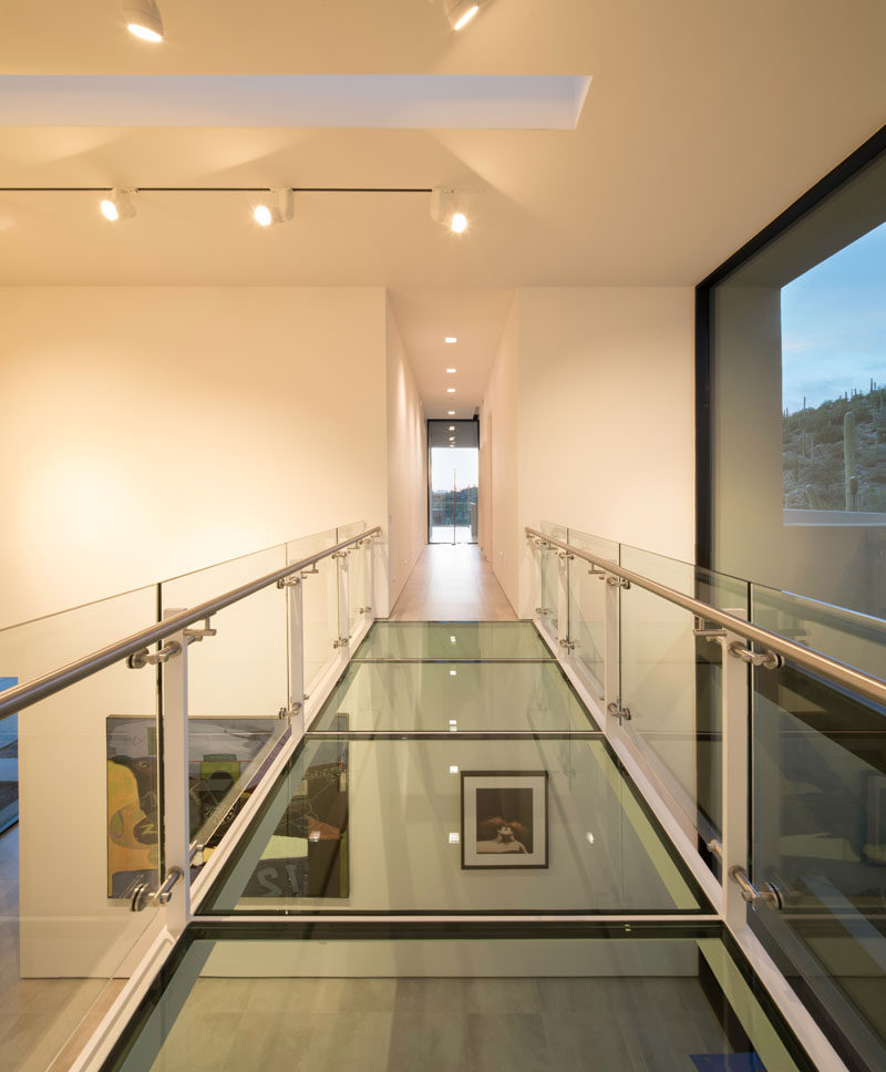 In this modern house, there's a glass bridge that crosses the art gallery and connects the living areas with the bedrooms. #GlassBridge #Architecture #GlassWalkway