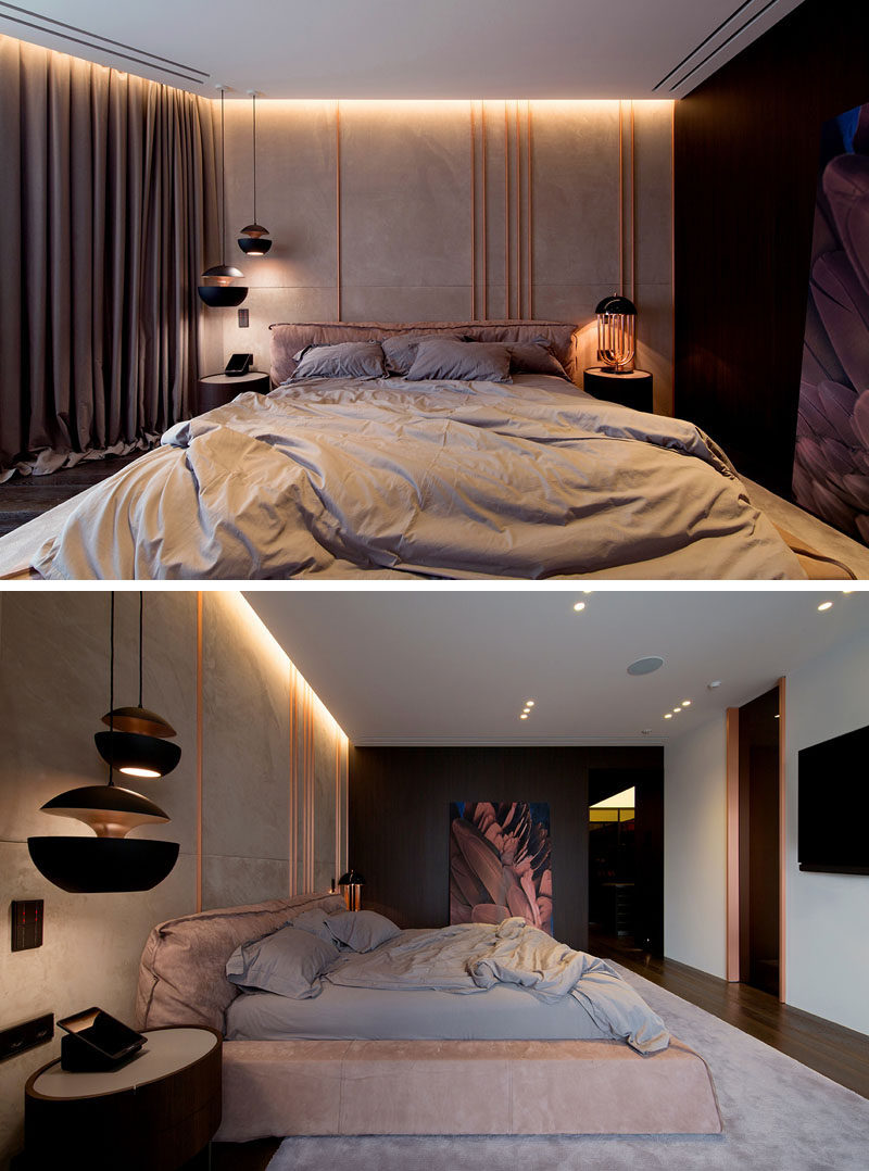 Copper elements have been used in this modern bedroom, with copper pipes featured on the wall behind the bed. Hidden lighting creates a dramatic yet relaxed atmosphere. #ModernBedroom #Copper