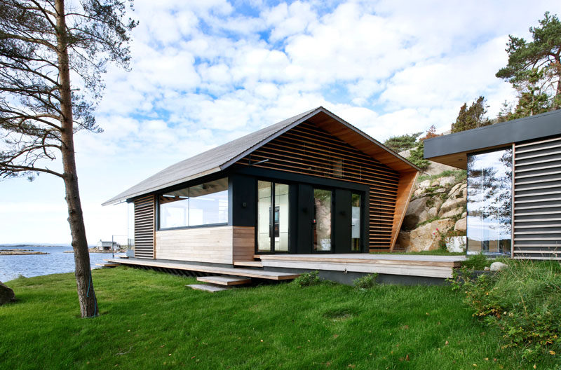 This modern cabin has a wood terrace that connects to a small building that houses a separate bedroom. #Cabin #Architecture