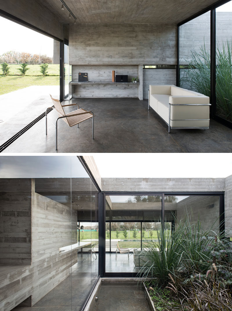 Large sliding glass walls open up the interior spaces of this modern concrete house to the backyard, and behind the living room is an inner patio with plants and another smaller water feature. #ConcreteHouse #LivingRoom #InnerPatio