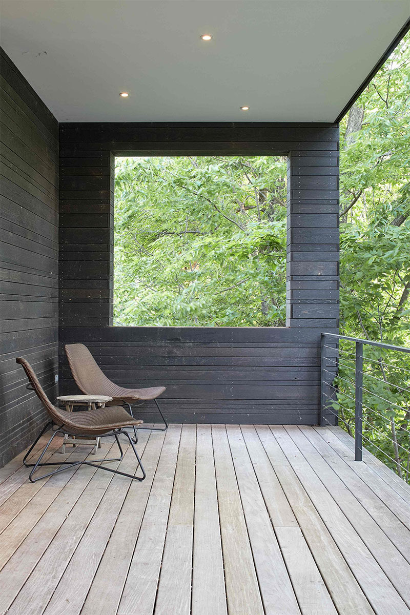 This modern, covered wood porch, sits at the front of a house and overlooks the street below. #CoveredPorch #ModernPorch