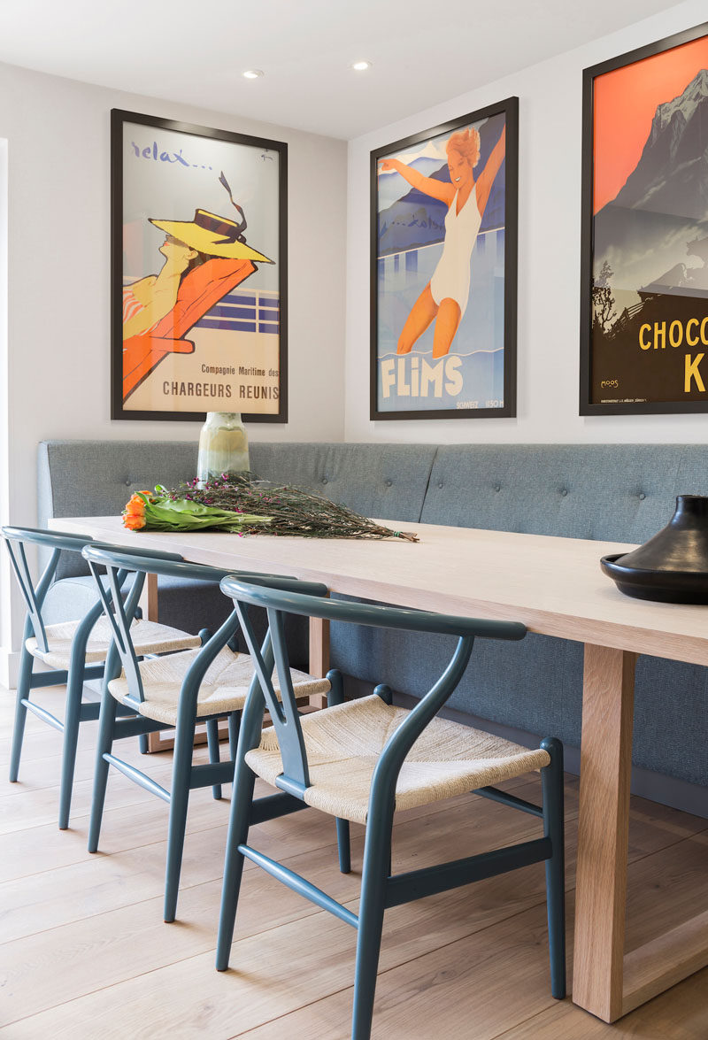 This contemporary dining nook features a bespoke fitted, grey upholstered banquette and a contemporary oak dining table that's able to seat 12 comfortably. #DiningNook #BanquetteSeating #DiningRoom