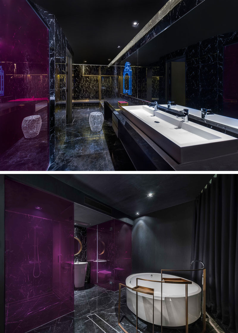 This modern hotel athroom features bright pink panels, while the bath can be closed off the hotel room with the use of curtains. #ModernBathroom #HotelBathroom #BlackBathroom