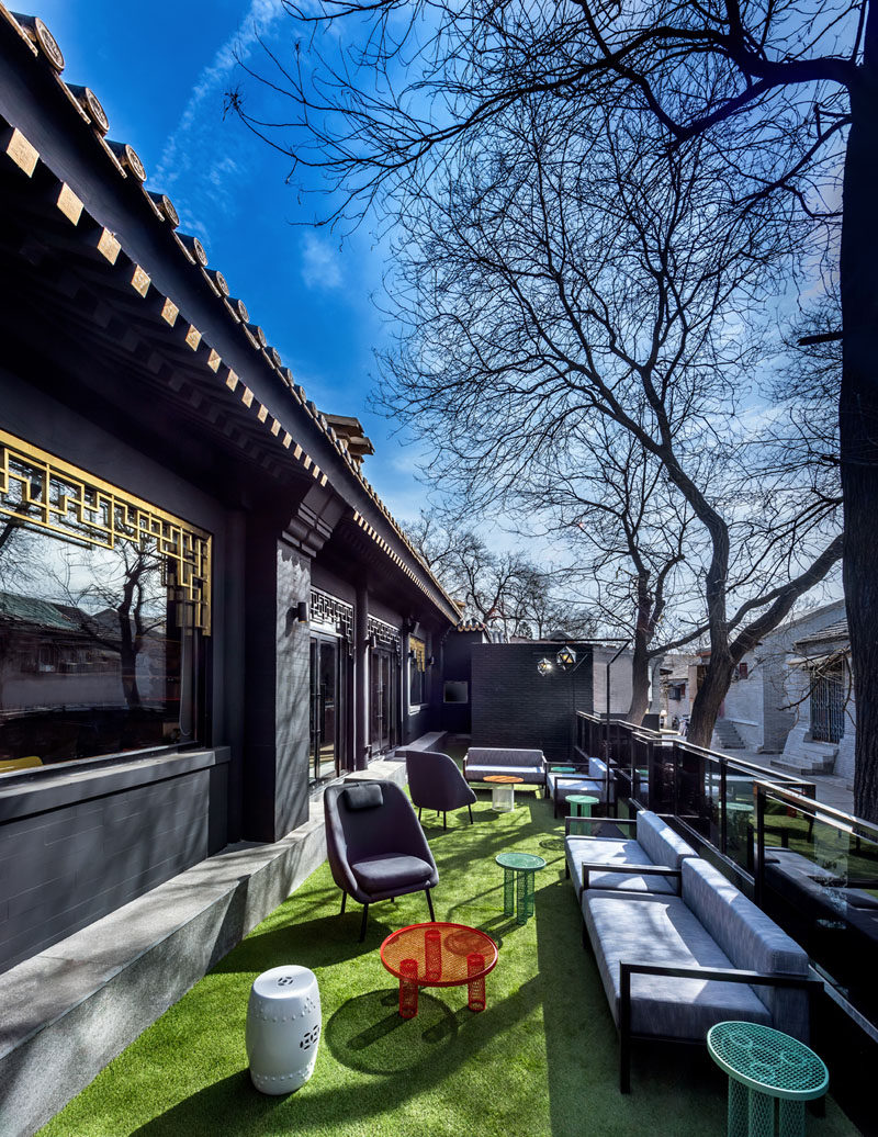 This hotel in Beijing, China, has an outdoor lounge area with couches and chairs, that overlooks the street and neighborhood. #OutdoorLounge #HotelDesign