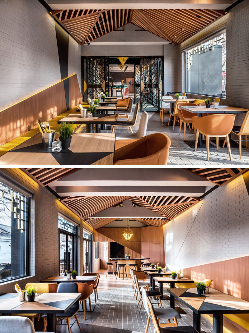 This modern café and bakery has a casual and vibrant atmosphere that's been created using wood and colorful accents. #Cafe #CafeDesign #InteriorDesign