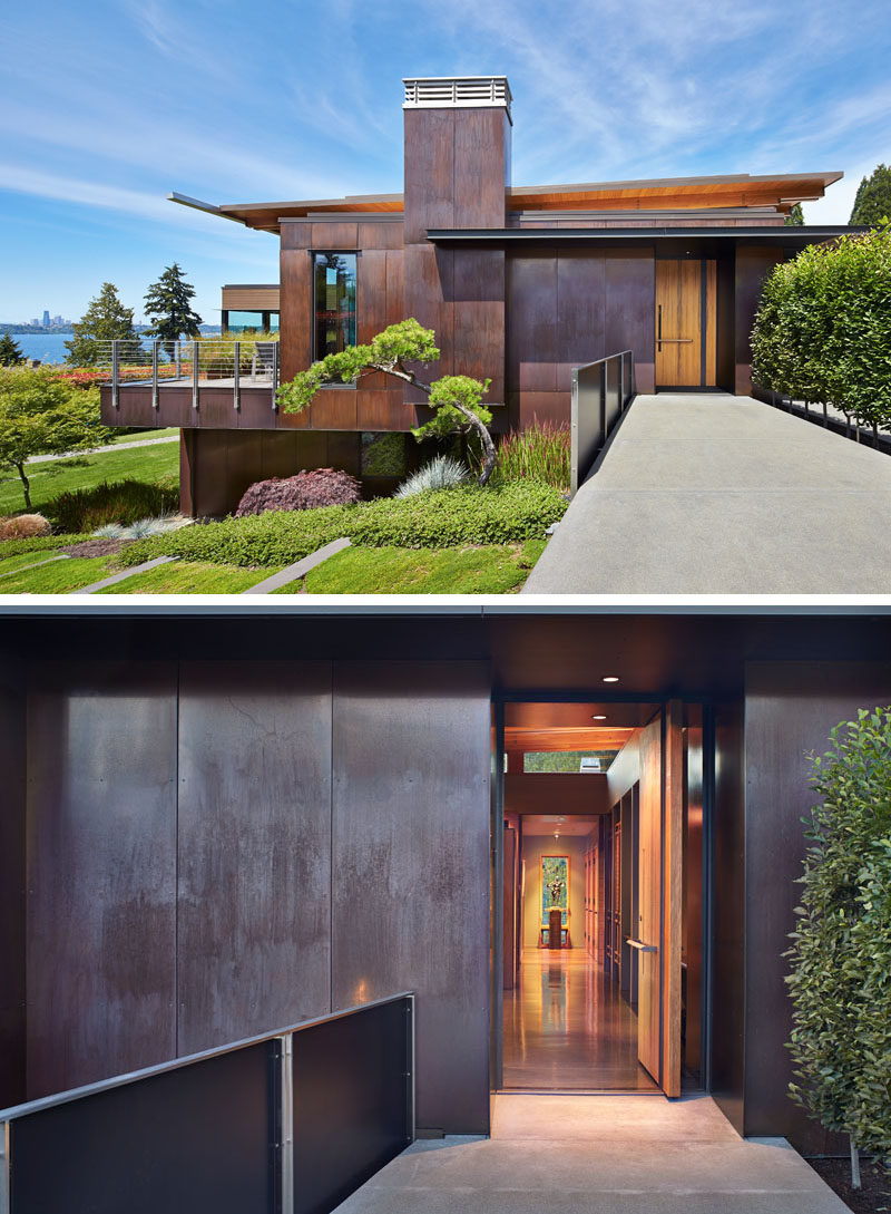 Dark-stained cedar siding and copper panels cover this modern house that has a cantilever and is nestled into a hillside on Mercer Island in Washington. #CedarSiding #CopperPanels #ModernHouse