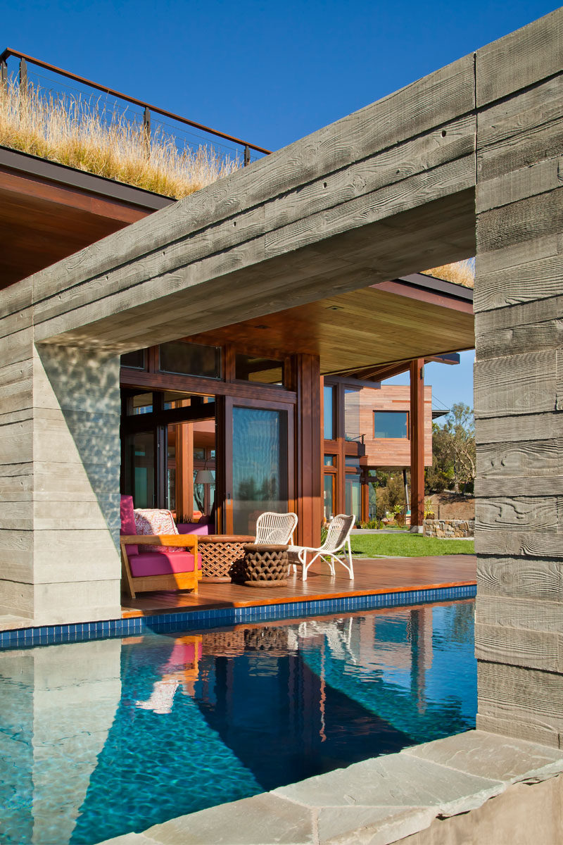 An arch over this modern swimming pool is part of the wall that continues through to the interior of the home. #SwimmingPool #Pool