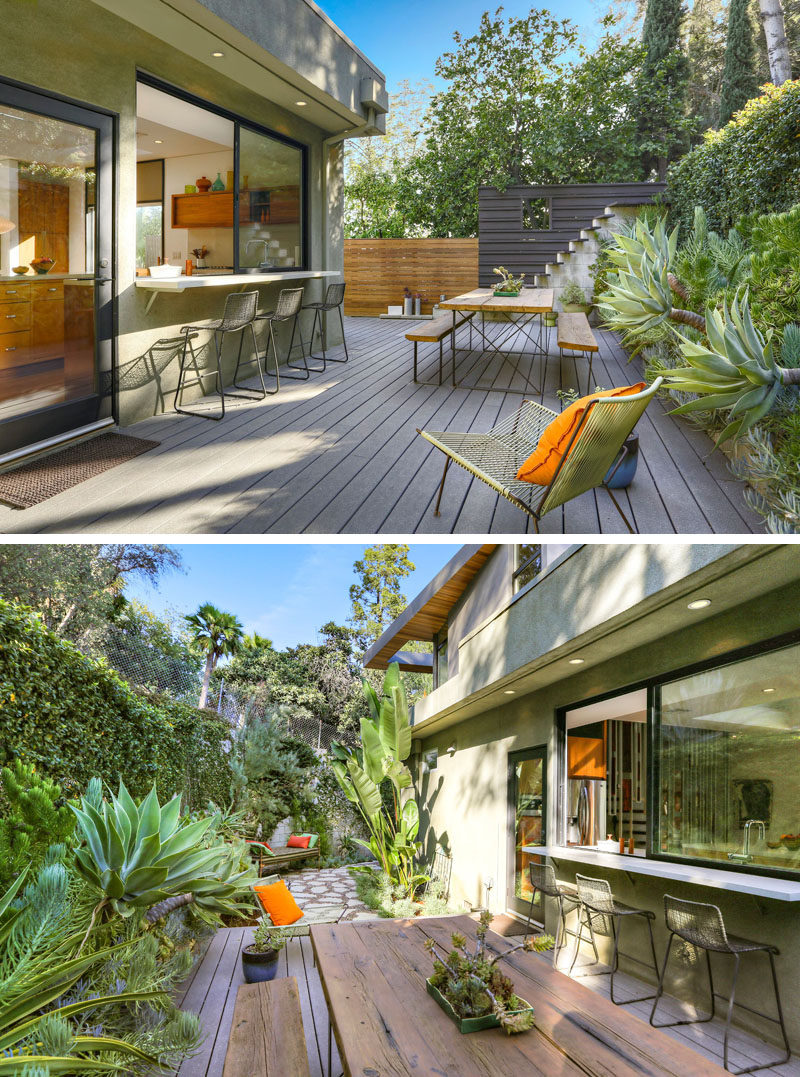 This modern outdoor space has been set up for outdoor dining. There's also bar seating at the kitchen window. #OutdoorSpace #OutdoorDining #Landscaping