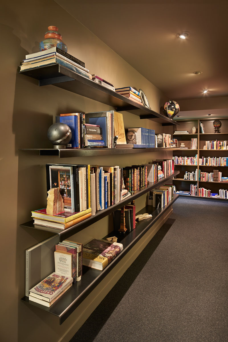 Custom steel shelving provides a place to display this home owners extensive book collection. #SteelShelving #Shelving