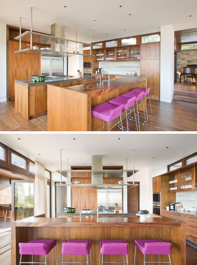 In this modern kitchen, there are two islands and walls of wood cabinets, creating plenty of counterspace and storage. #ModernKitchen #WoodKitchen #KitchenDesign