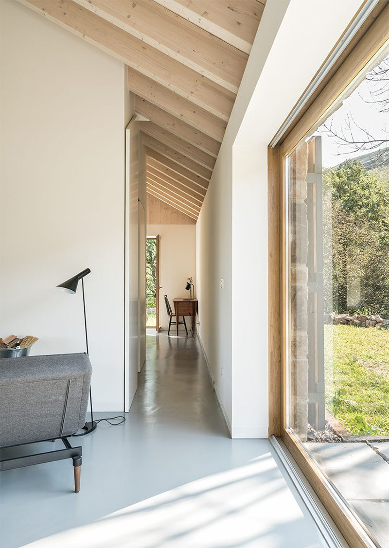 This stone cottage has two bedrooms that are located down small hallways on either side of the living room. #Cottage #InteriorDesign #Hallway