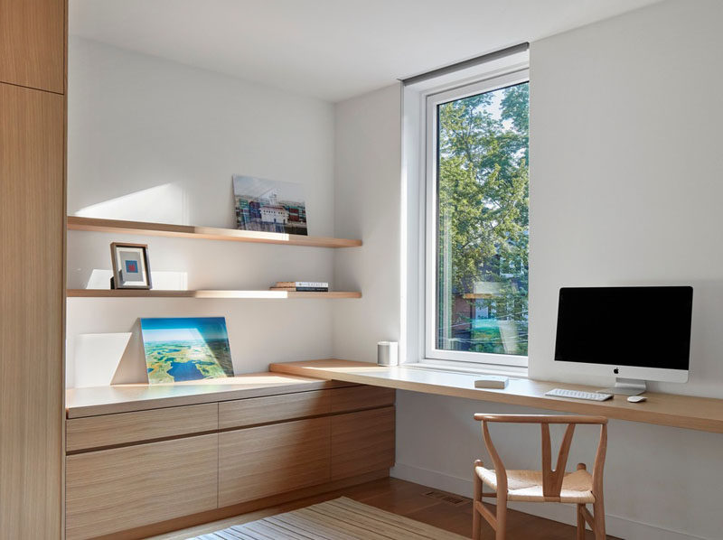 This modern room has built-in wood cabinetry that meets a simple wood desk. Wood shelving provides a place to display personal items. #WoodDesk #ModernDesk #Shelving