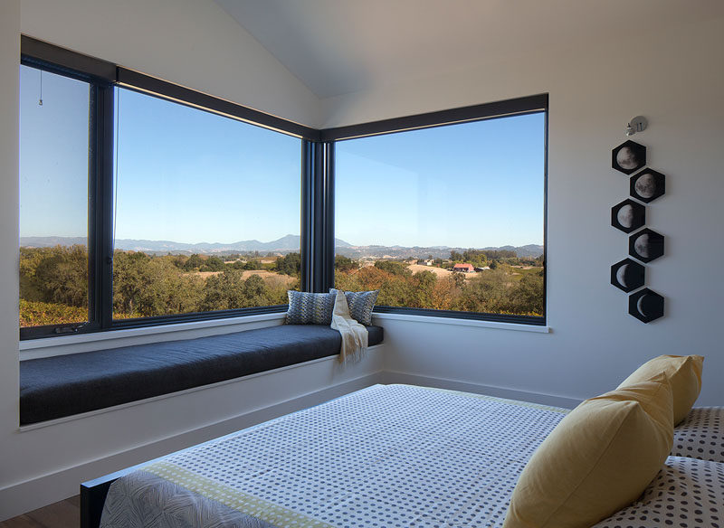 In this modern bedroom, a built-in window seat provides a place to take in the scenery from the windows. #WindowSeat #BedroomDesign #Windows