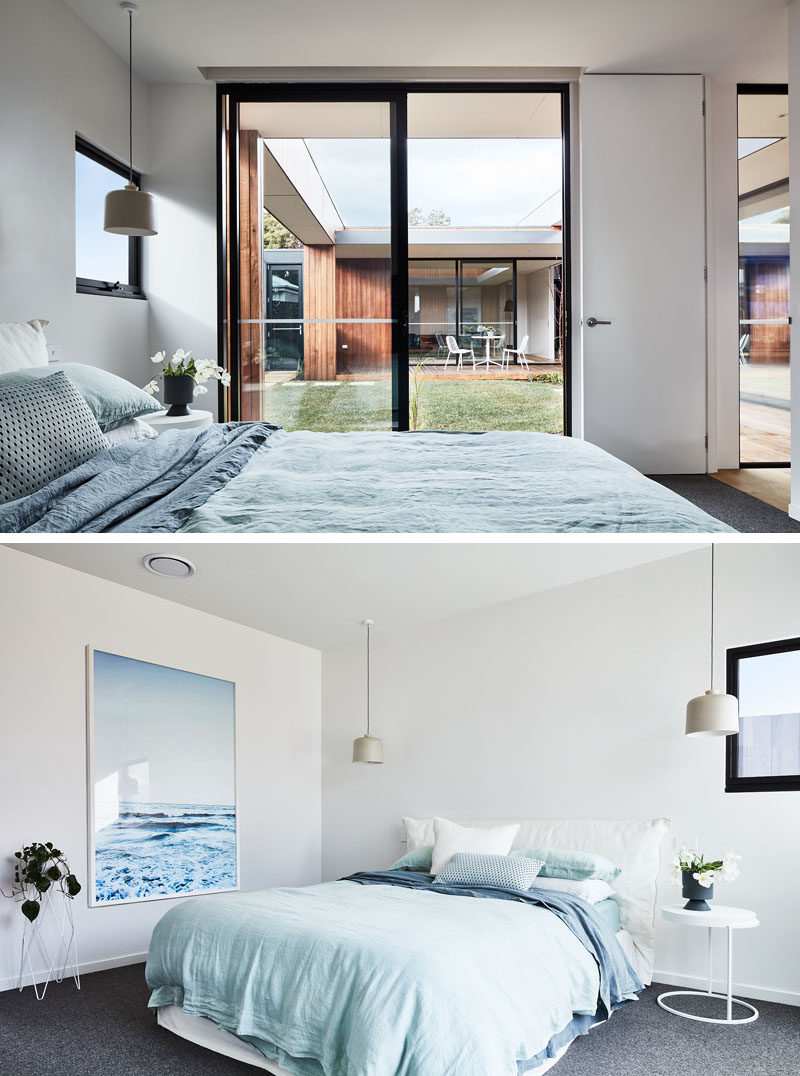 In this modern bedroom, light blue accents create a calm and relaxing environment, while the sliding door and a window provide plenty of natural light. #ModernBedroom #LightBlue