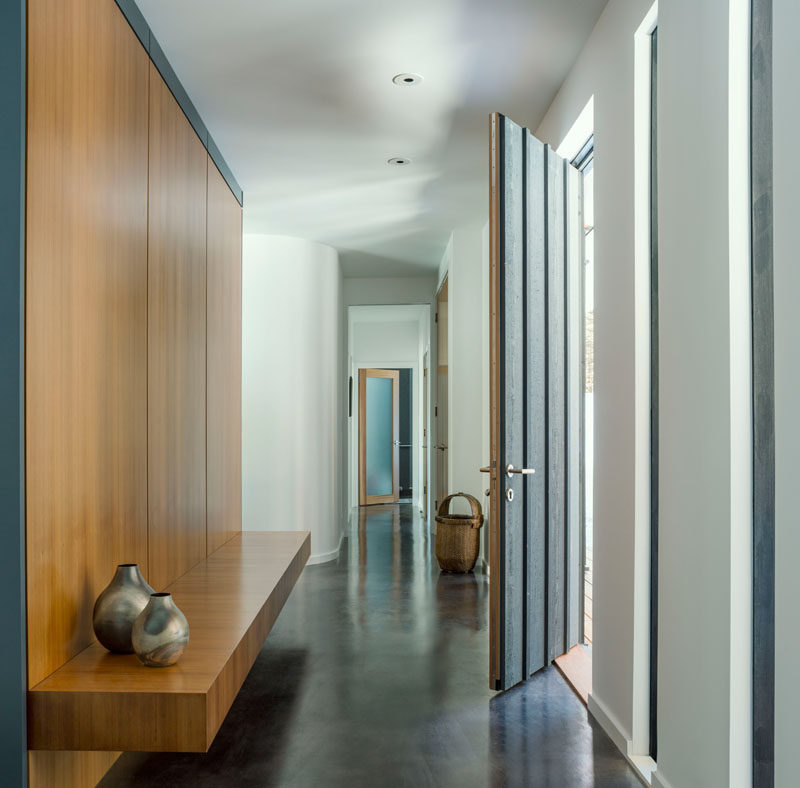 The interior of this modern house has a minimalist palette of finished concrete floors, painted walls and western red cedar details. #Minimalist #ModernHouseInterior #ConcreteFloors #InteriorDesign