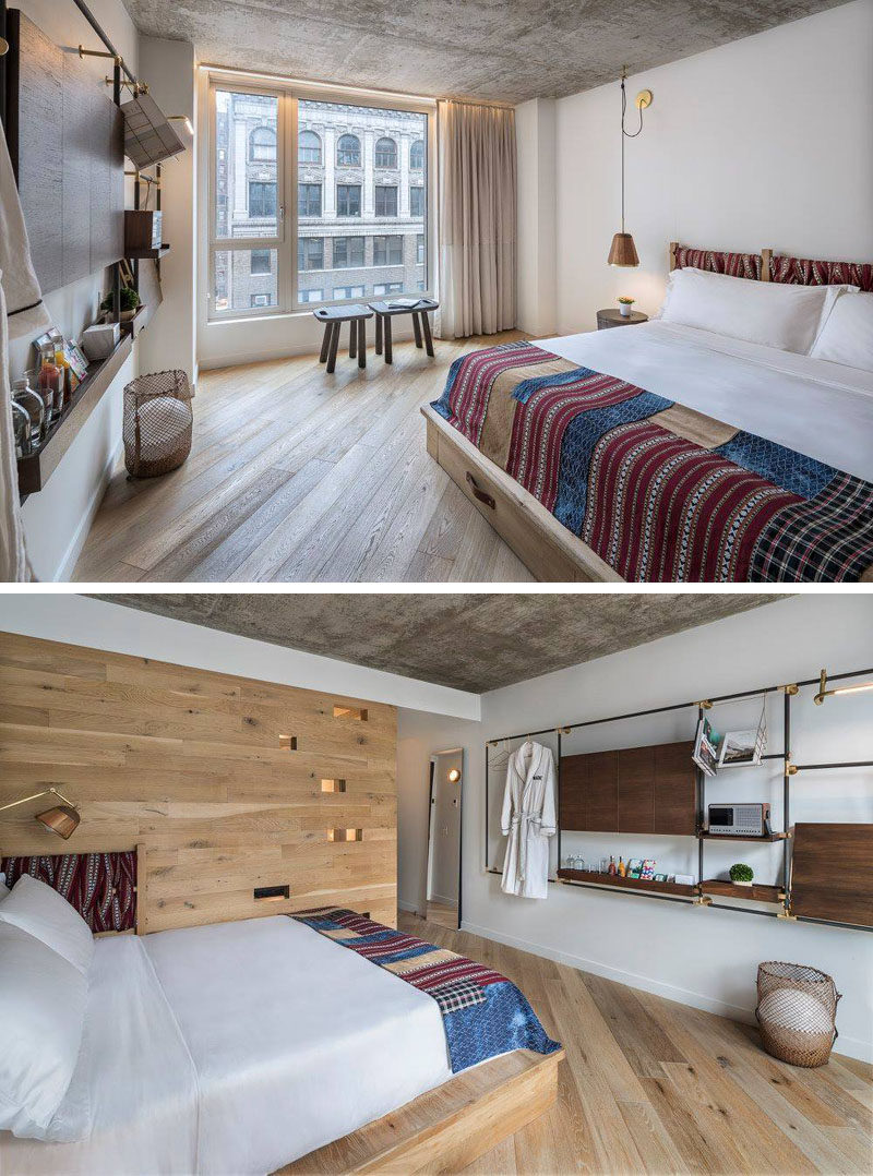 In this modern hotel room, a custom wall unit features walnut shelving and drop down desks, while color has been added with the use of headboards and blankets. #ModernHotelRoom #HotelRoom