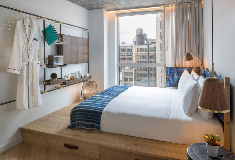 In this modern hotel rooms, the beds are raised up onto a wood platform, allowing for storage drawers to be tucked away underneath the bed. #ModernHotelRoom #PlatformBed #MADEHotel