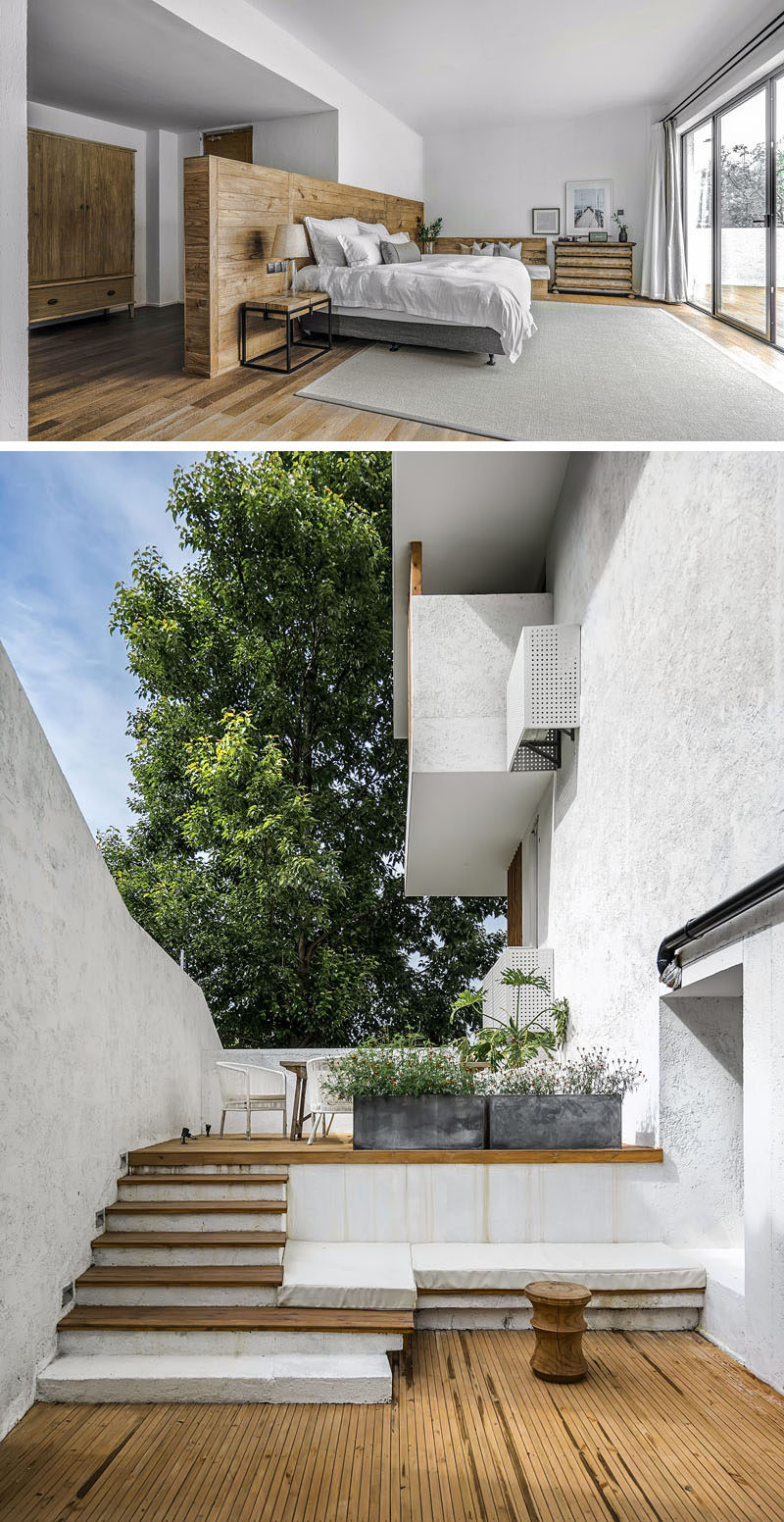 In this modern hotel room, a wood pony wall doubles as a headboard for the bed, while outside, there's a private patio. #ModernHotelRoom #Patio