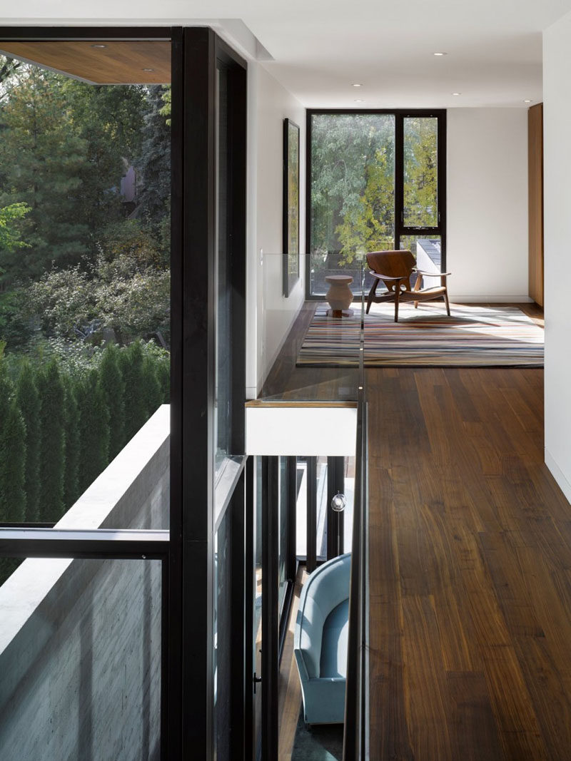 This modern house has rich wood floors and an open family room that overlooks the backyard. #WoodFlooring #Windows #InteriorDesign