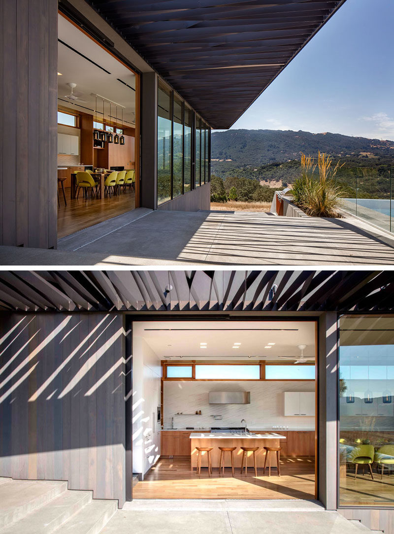 Large sliding doors open the main living area of this modern house to the partially covered patio. #SlidingDoors