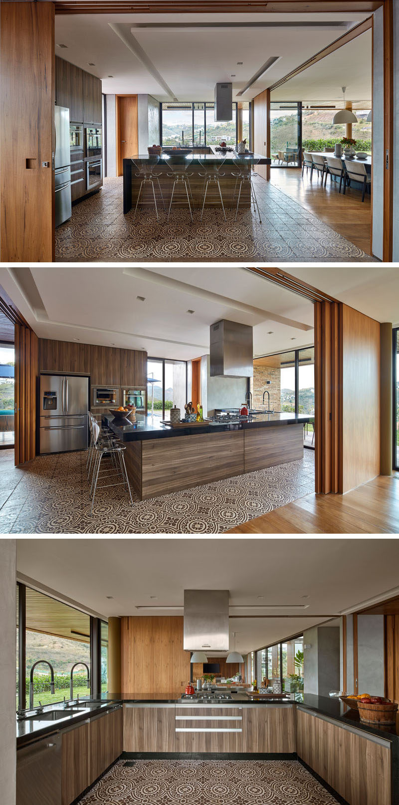 Wood walls open to reveal the kitchen and extends the living area of this modern house. Patterned tiles help to define the kitchen, while a black countertop contrasts the rich wood cabinets. #ModernKitchen #SlidingWoodWalls #InteriorDesign