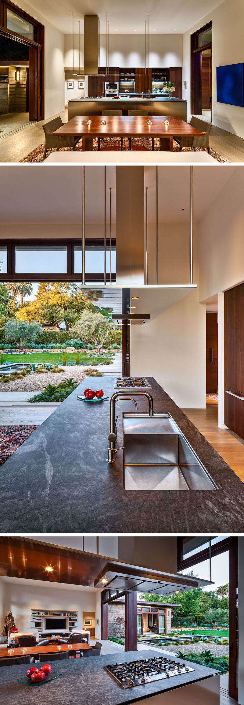 In this modern kitchen, wood cabinets have been paired with a gray soapstone countertops and an island with stainless steel fronts. Above the island is an integrated range hood with suspended lighting. #ModernKitchen #SoapstoneCountertop #StainlessSteelKitchenCabinets