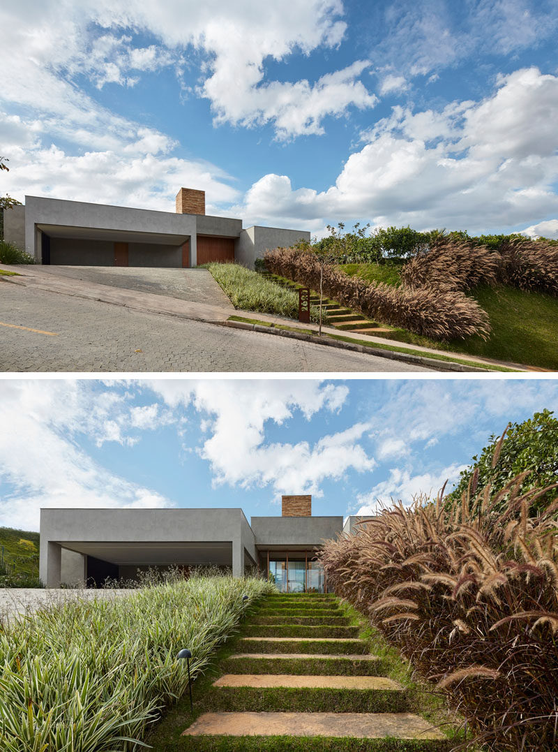 This modern house in Brazil, which sits on a slope, has stairs that are embedded into the hill and are surrounded by grass. #Landscaping #Garden #OutdoorStairs