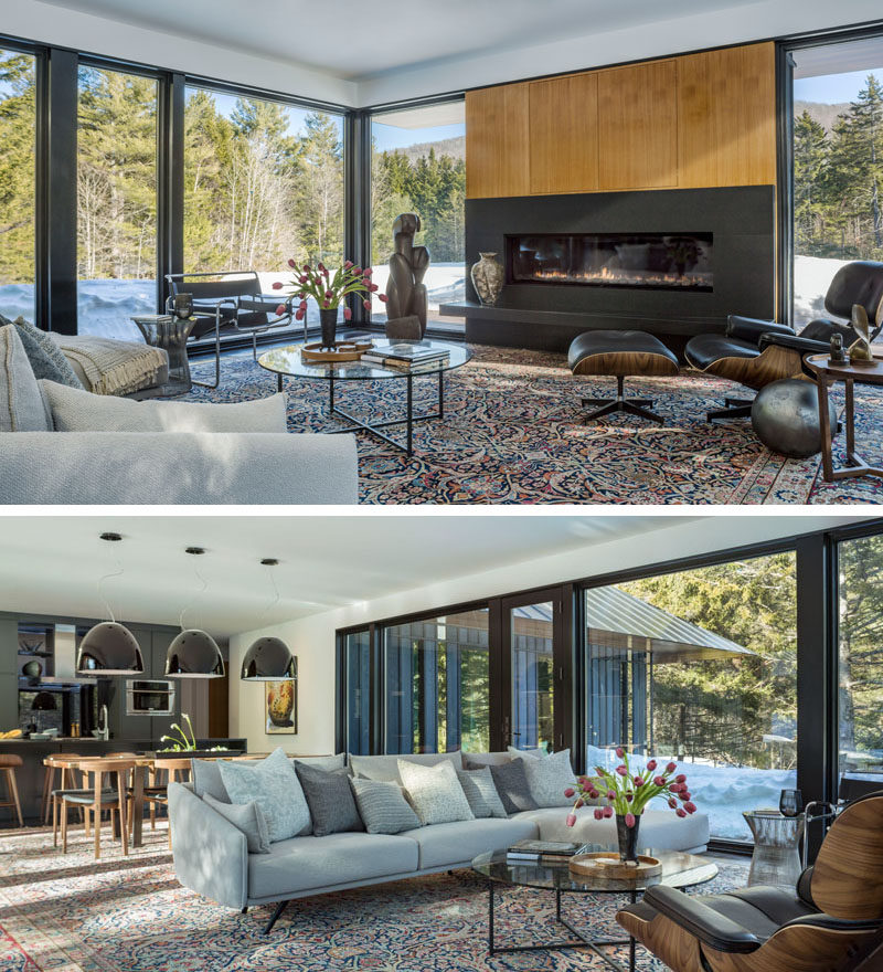 In this modern living room, a horizontal fireplace breaks up the large windows that flood the room with natural light and provide a view of the landscape. The living room also shares the space with the dining room and kitchen.