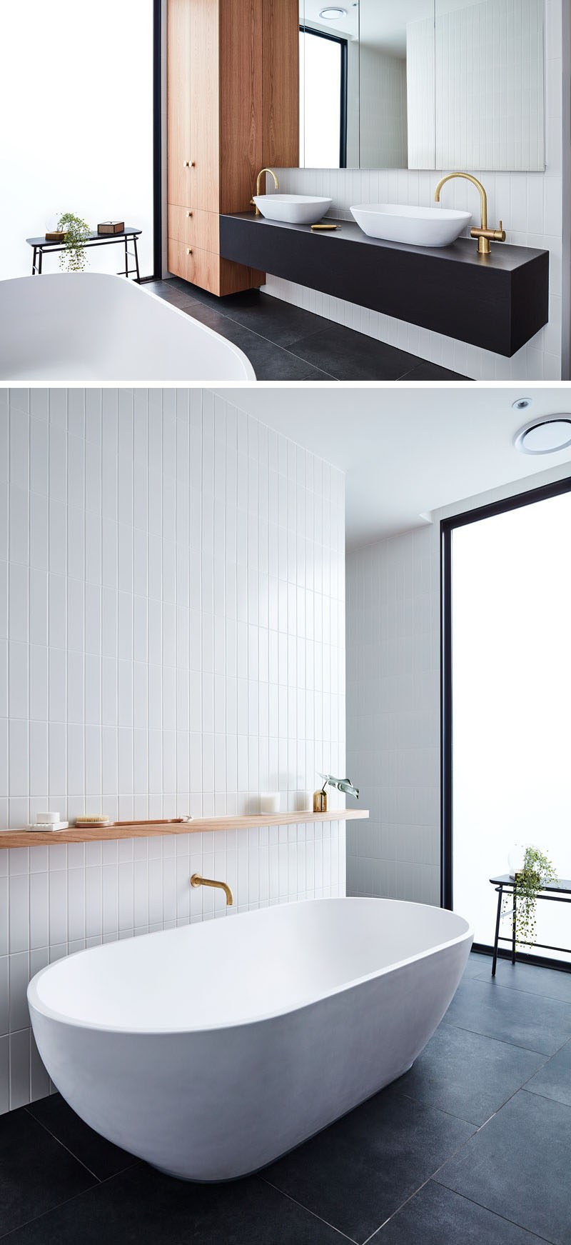 In this modern bathroom, black flooring and a black vanity contrast the white freestanding bathtub and accent tile wall, while the wood cabinets and a plant add a natural element. #ModernBathroom #BathroomDesign