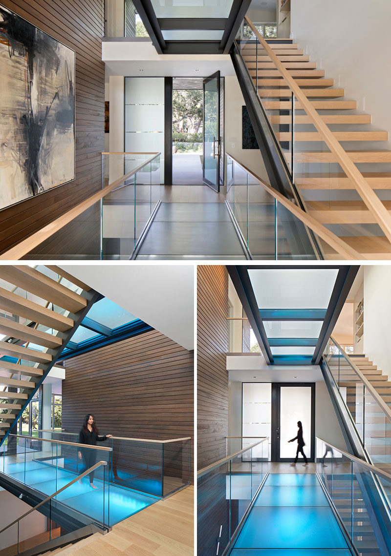 Inside this modern house, a 3-level glass bridge and open tread stair illuminates the circulation of the home. Skylights from above filter natural light down thru to the basement and LEDs light each glass bridge for a playful pop of color. #GlassBridge #Stairs #ModernHouse