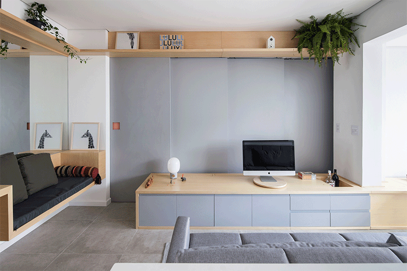 Estúdio BRA have renovated a small apartment in Sao Paulo, Brazil, that's just 409 square feet (32m2) and has a hidden bedroom. #HiddenBedroom #ApartmentDesign #SlidingWall