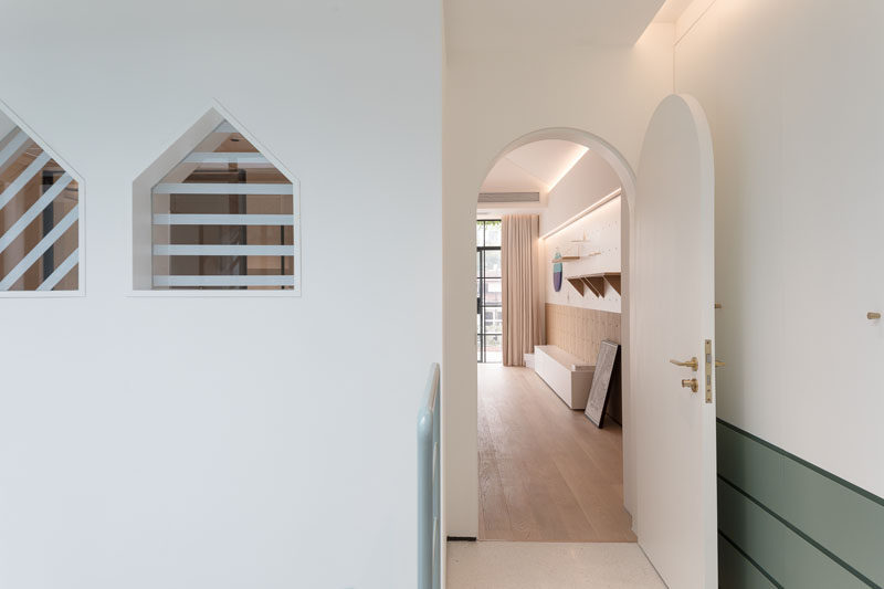 This renovated home has arched doorways and small triangle shaped windows. #ModernDoor