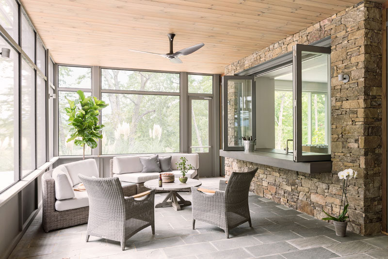 This screened-in porch is a relaxing spot with a couple of curved couches and views of the surrounding landscape. #Porch #EntertainingSpace