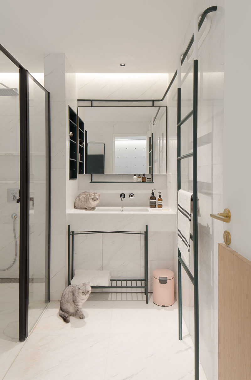 In this modern master bathroom, black accents have been used to contrast the white walls, ceiling and floor. #ModernBathroom #BathroomDesign #WhiteBathroom