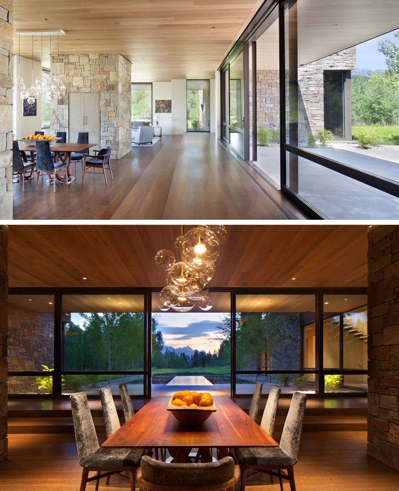 Inside this modern house, white oak wood floors are used throughout, while in the dining area, the wood dining table lines up with the water feature outside. #OakFlooring #DiningRoom