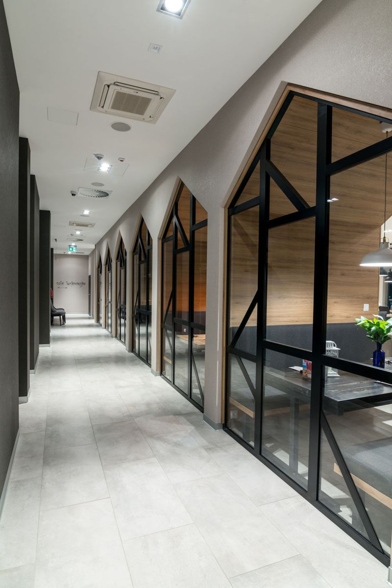 In this contemporary hotel, there's a view of the dining alcoves in the restaurant from the hallway. #HotelDesign #Windows