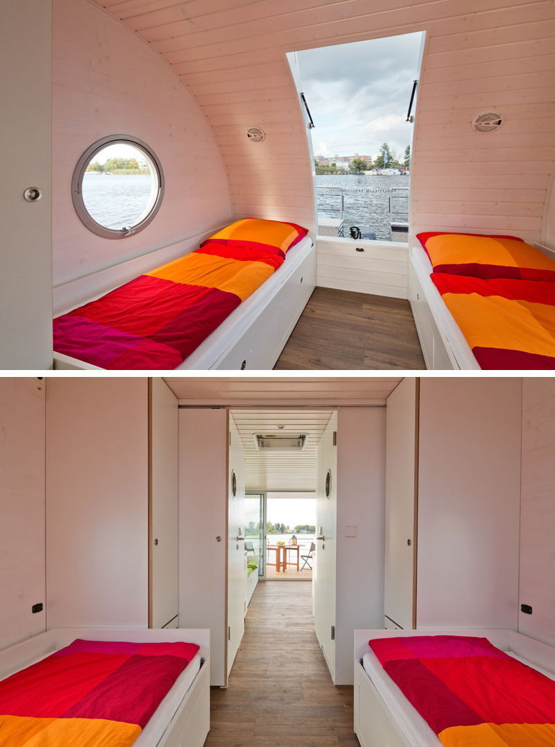 This modern houseboat has a bedroom with two beds and a pull out bed underneath. Closets at the end of the bed create additional storage space, while a curved window and portholes allow natural light to filter into the room. #ModernHouseboat #Houseboat