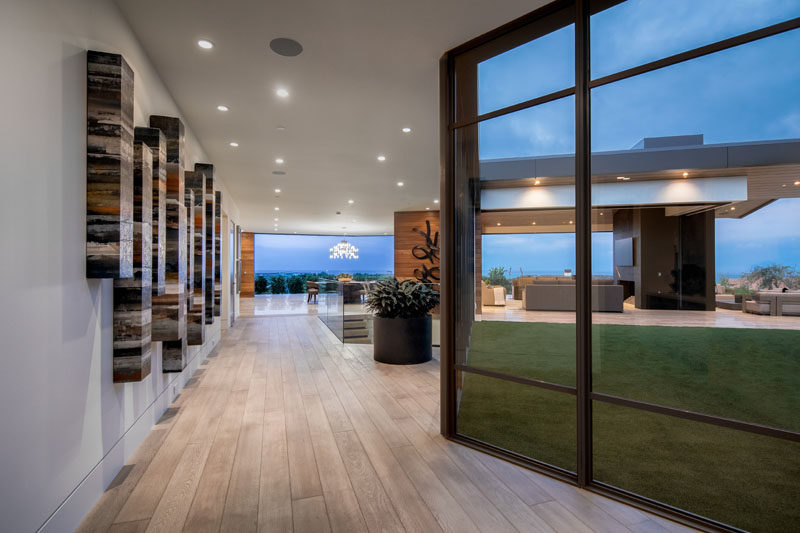 This modern hallway is lined by floor-to-ceiling windows that provide plenty of light to the interior. #ModernHallway #Windows