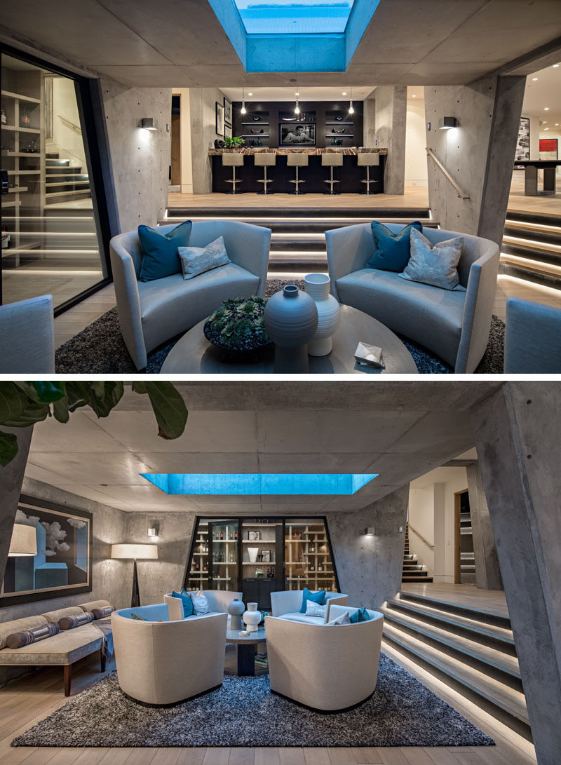 In the basement of this modern house, exposed concrete walls frame the wine room and the lounge that sit directly below the pool. #ModernLounge #ModernBar