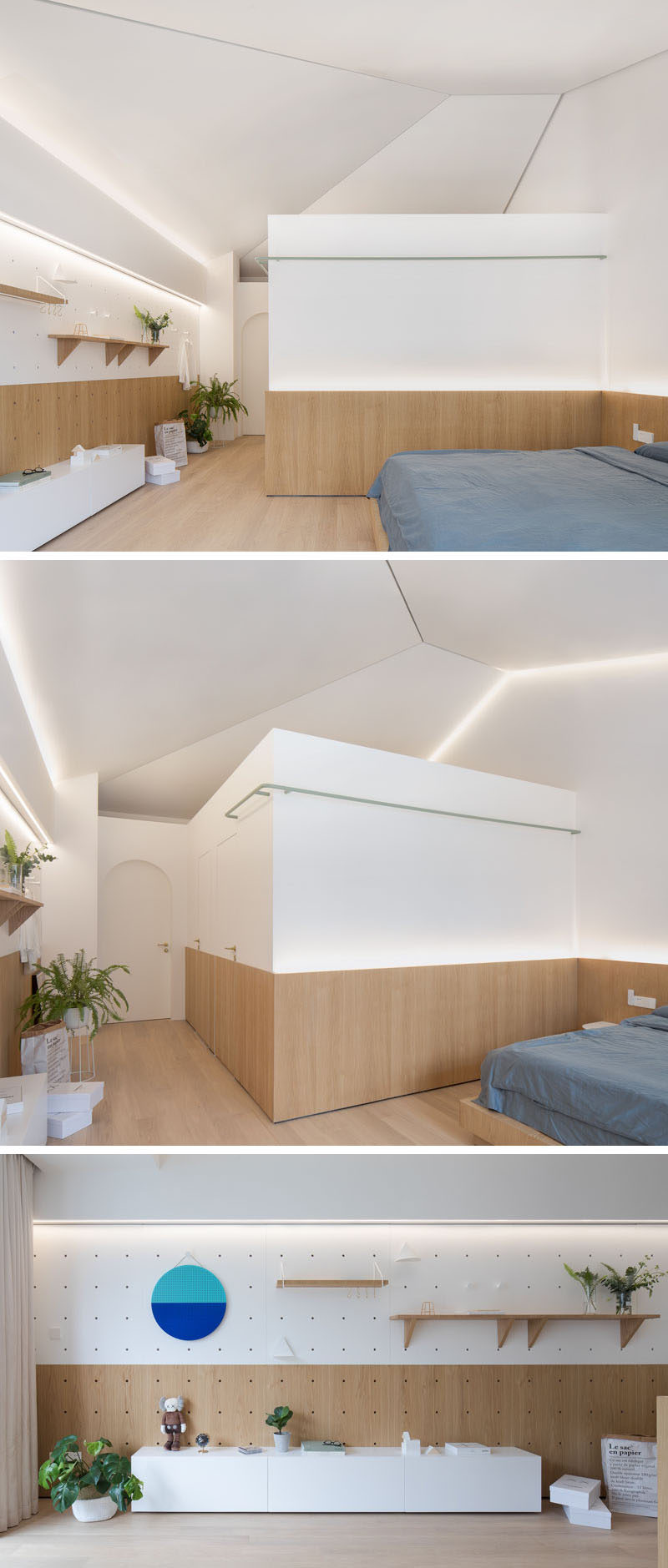 In this renovated master bedroom, the designers kept the sloped ceiling structure of the original building. Wood wraps around the lower part of the room, and on the wall opposite the bed, there's a display wall which can be changed up, much like the wall in the living room. #ModernBedroom #MasterBedroom #Shelving