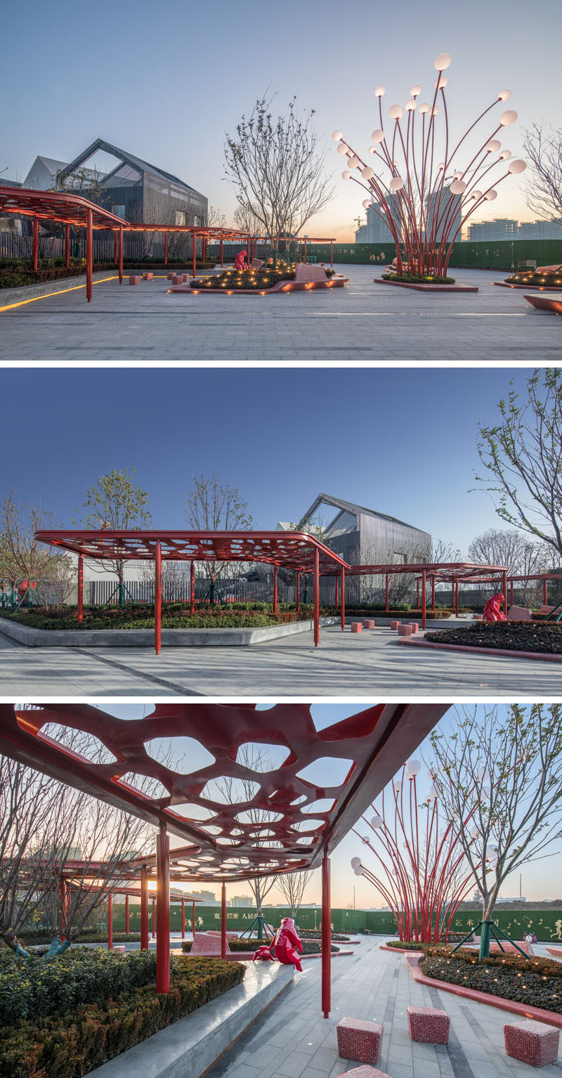 This modern public plaza has a variety of seating options, like a built-in concrete bench that sits underneath a red pergola and that wraps around the planters. #Park #Plaza #LandscapeDesign