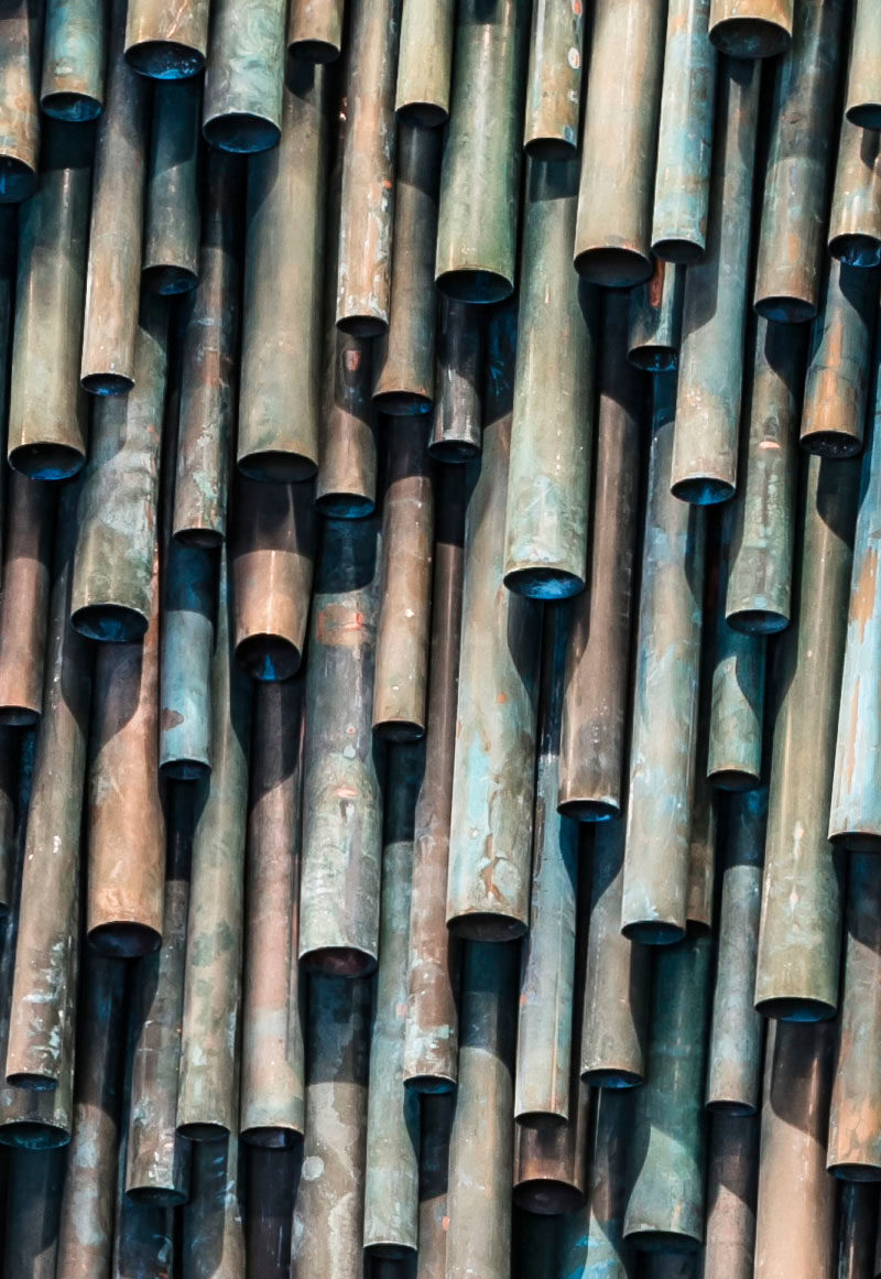 Designer Raphael Navot has used oxidised copper tubes to create a unique and interesting accent wall in a restaurant within a hotel. #AccentWall #Copper #Design