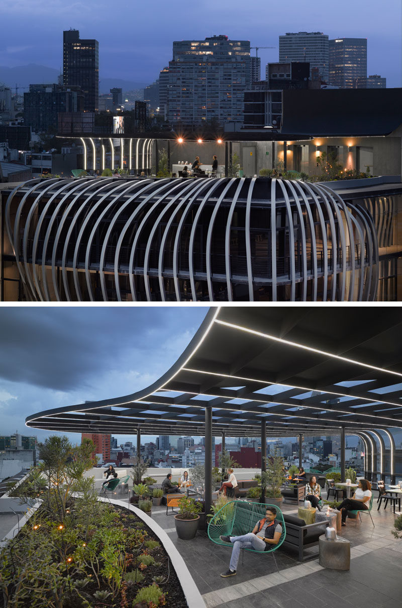 This modern office building has a sculptural facade and a rooftop patio with plenty of seating options. #ModernBuilding #Architecture #RooftopPatio